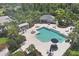 An aerial view of a community pool with lounge chairs and shady picnic area at 4811 Woodbrook Dr, Sarasota, FL 34243