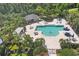 An aerial view of a community pool, lounge, and pergola surrounded by palm trees at 4811 Woodbrook Dr, Sarasota, FL 34243