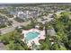 Aerial view showcases a community pool, cabana, and manicured landscaping among a neighborhood of well-maintained homes and lush trees at 4811 Woodbrook Dr, Sarasota, FL 34243
