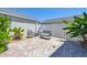 Relaxing backyard area featuring patio seating and lush tropical landscaping at 4811 Woodbrook Dr, Sarasota, FL 34243