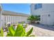 Serene backyard with comfortable seating surrounded by lush greenery and a white privacy fence at 4811 Woodbrook Dr, Sarasota, FL 34243