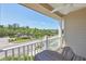 Balcony with a wooden table, white railing and a view of the neighborhood at 4811 Woodbrook Dr, Sarasota, FL 34243