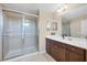 Bright bathroom featuring a glass shower and a vanity with dark wood cabinets and a white countertop at 4811 Woodbrook Dr, Sarasota, FL 34243