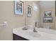 Stylish bathroom featuring beach-themed art and a vanity with a spacious countertop at 4811 Woodbrook Dr, Sarasota, FL 34243