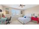 Cozy bedroom with beach-themed decor, a bed, a desk, and a colorful accent table at 4811 Woodbrook Dr, Sarasota, FL 34243