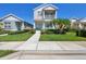 Charming two-story home features a balcony, well-manicured lawn, and inviting front porch, exuding curb appeal at 4811 Woodbrook Dr, Sarasota, FL 34243
