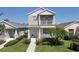 Charming two-story home featuring a balcony, a well-manicured lawn, and inviting curb appeal with lush landscaping at 4811 Woodbrook Dr, Sarasota, FL 34243