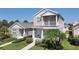 Charming two-story home featuring a balcony, a well-manicured lawn, and inviting curb appeal with lush landscaping at 4811 Woodbrook Dr, Sarasota, FL 34243