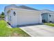 An attached two-car garage with carriage lights and a concrete drive at 4811 Woodbrook Dr, Sarasota, FL 34243
