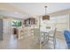 Bright eat-in kitchen features stainless appliances, white counters, dark wood cabinets, and pendant lighting at 4811 Woodbrook Dr, Sarasota, FL 34243