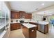 Bright kitchen features stainless appliances, white counters, dark wood cabinets, and large windows at 4811 Woodbrook Dr, Sarasota, FL 34243
