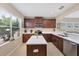 This kitchen features stainless steel appliances, wooden cabinets and an island at 4811 Woodbrook Dr, Sarasota, FL 34243