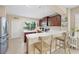 Kitchen with stainless steel appliances, dark cabinets, white countertop and breakfast bar at 4811 Woodbrook Dr, Sarasota, FL 34243