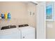 Well-lit laundry room includes a side-by-side washer and dryer at 4811 Woodbrook Dr, Sarasota, FL 34243