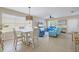 Spacious living area with tile flooring, a ceiling fan, abundant natural light, and a dining table and chairs at 4811 Woodbrook Dr, Sarasota, FL 34243