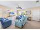 Bright living room features tile floors, ceiling fan, comfortable seating, and abundant natural light at 4811 Woodbrook Dr, Sarasota, FL 34243