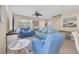 Cozy living room with ceiling fan, comfortable seating, tile floors, and beach-themed accents at 4811 Woodbrook Dr, Sarasota, FL 34243