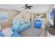 Comfortable living room with beach-themed decor, tile flooring, ceiling fan, and adjacent dining area at 4811 Woodbrook Dr, Sarasota, FL 34243