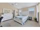 Bright main bedroom with a ceiling fan, two windows and a white dresser at 4811 Woodbrook Dr, Sarasota, FL 34243