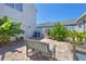 Private brick patio with lush plantings and comfortable seating at 4811 Woodbrook Dr, Sarasota, FL 34243