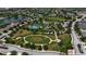 Community aerial view of park featuring tennis courts, playground, and green space at 5036 Brickell Park Cv, Bradenton, FL 34211