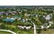 Aerial view of community park featuring tennis courts, playground, and green spaces at 5036 Brickell Park Cv, Bradenton, FL 34211