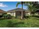 Home featuring a screened-in porch, well-maintained lawn, and lush greenery, offering a serene outdoor space at 5036 Brickell Park Cv, Bradenton, FL 34211
