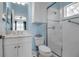 Stylish bathroom featuring a glass shower, tiled walls, window, toilet with shelves and modern sink vanity at 5036 Brickell Park Cv, Bradenton, FL 34211
