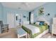 Stylish bedroom with an adjacent bathroom, ceiling fan, plantation shutters and modern decor at 5036 Brickell Park Cv, Bradenton, FL 34211