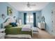 Light filled bedroom with a ceiling fan, plantation shutters, and stylish decor at 5036 Brickell Park Cv, Bradenton, FL 34211
