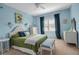 Bedroom with ceiling fan, plantation shutters and stylish decor with blue accents at 5036 Brickell Park Cv, Bradenton, FL 34211