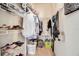 Walk-in closet with metal shelving, hanging clothes, bags, and organizing containers for optimal storage solutions at 5036 Brickell Park Cv, Bradenton, FL 34211