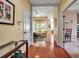 Inviting entryway featuring hardwood floors, neutral walls, and views into the living and dining areas at 5036 Brickell Park Cv, Bradenton, FL 34211