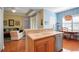 Kitchen featuring wooden cabinets, stainless dishwasher, and breakfast bar open to living area at 5036 Brickell Park Cv, Bradenton, FL 34211