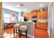 Charming eat-in kitchen boasts wooden cabinets, stainless appliances, and hardwood floors at 5036 Brickell Park Cv, Bradenton, FL 34211