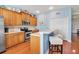Bright eat-in kitchen with stainless appliances, light wood cabinets, breakfast bar and wood flooring at 5036 Brickell Park Cv, Bradenton, FL 34211