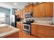Spacious kitchen with stainless steel appliances, light wood cabinetry, and ample counter space at 5036 Brickell Park Cv, Bradenton, FL 34211