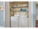 Laundry closet featuring a washer, dryer, and shelving for storage at 5036 Brickell Park Cv, Bradenton, FL 34211