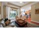 Bright living room leads to outdoor patio and features hardwood floors and open kitchen at 5036 Brickell Park Cv, Bradenton, FL 34211
