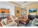 Inviting living room open to kitchen features hardwood floors and stylish, comfortable furnishings at 5036 Brickell Park Cv, Bradenton, FL 34211