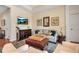 Relaxing living room with hardwood floors, plush seating, and a decorative media center at 5036 Brickell Park Cv, Bradenton, FL 34211