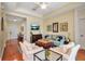 Comfortable living room boasts hardwood floors, neutral walls, and ample seating space at 5036 Brickell Park Cv, Bradenton, FL 34211