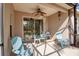 Covered patio with seating and a ceiling fan, leading to a screened in area at 5036 Brickell Park Cv, Bradenton, FL 34211
