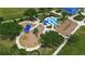 Aerial view of the community playground, featuring slides, splash pad, and covered play areas at 5036 Brickell Park Cv, Bradenton, FL 34211