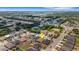 An aerial view shows a suburban neighborhood featuring single-Gathering homes, green spaces, and nearby commercial area at 5111 11Th E St, Bradenton, FL 34203
