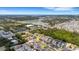 An aerial view captures a residential area near a tranquil lake and recreational facilities in a beautiful community at 5111 11Th E St, Bradenton, FL 34203