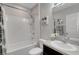 Bright bathroom features a shower-tub combo with white tile surround, plus a granite countertop vanity at 5111 11Th E St, Bradenton, FL 34203