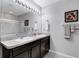 Bright bathroom featuring a double vanity, neutral walls, and a framed mirror at 5111 11Th E St, Bradenton, FL 34203