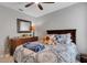 A cozy bedroom featuring teddy bears, ceiling fan, wooden furniture, and relaxing atmosphere at 5111 11Th E St, Bradenton, FL 34203