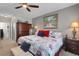 Comfortable bedroom featuring floral bedding, ceiling fan, and side tables with reading lamps at 5111 11Th E St, Bradenton, FL 34203